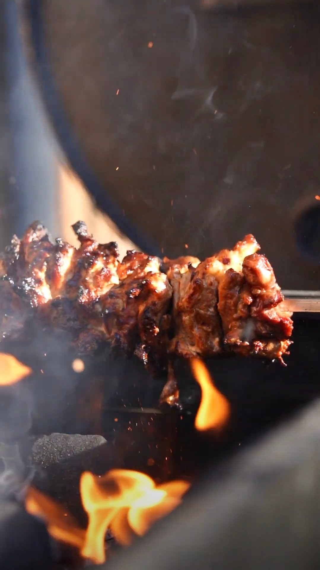 Chicken cooking over open flames at a Grill Seekers event